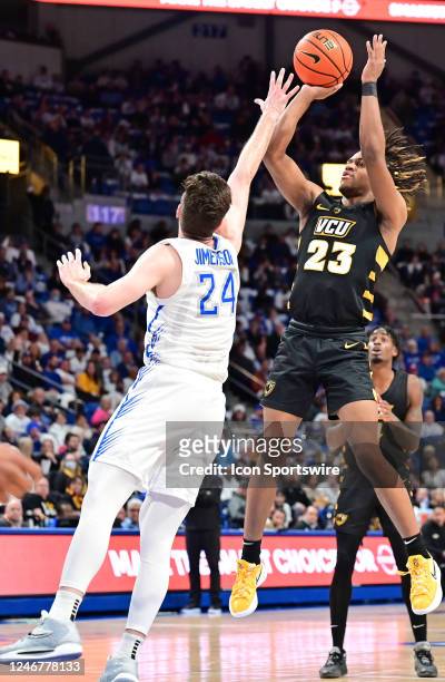 Guard Jayden Nunn attempts a three-point play as Saint Louis University guard Gibson Jimerson defends during a college basketball game between the...