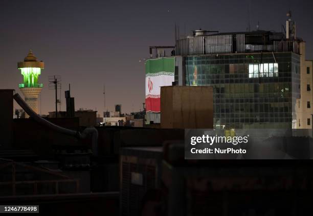 Building is covered with an Iran flag in downtown Tehran at midnight on February 4, 2023. MORTEZA NIKOUBAZL/NurPhoto