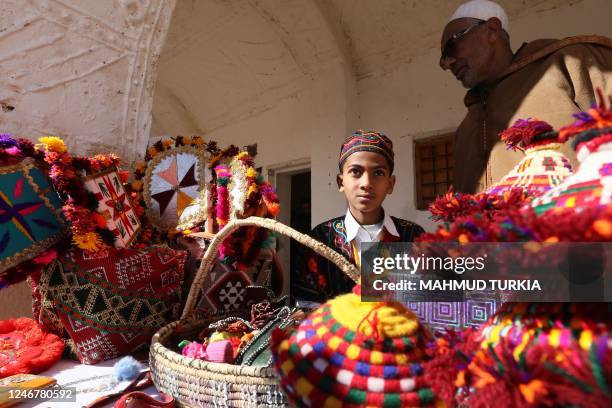 Young boy dressed in colourful dress poses for a picture during the opening of the Ghadames festival in the Libyan town of Ghadames, a desert oasis...