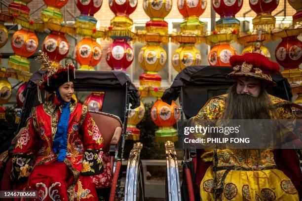 Performers in traditional Chinese costumes prepare to take part in a Lunar New Year parade, held for the first time following a three-year hiatus due...