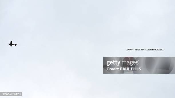 Plane carrying the message "League's worst-run club" flies over Goodison Park during the English Premier League football match between Everton and...