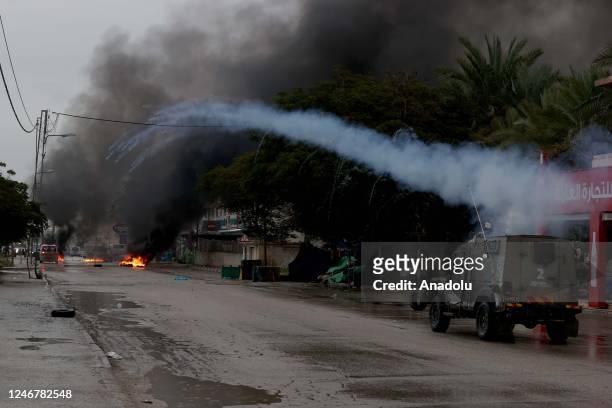 Israeli forces launch tear gas canisters as they intervene with Palestinians following an operation at the Aqbat Jabr Camp in Jericho, West Bank on...
