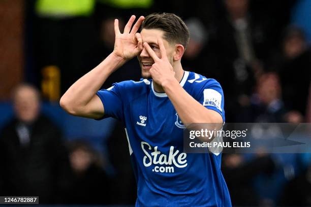 Everton's English defender James Tarkowski celebrates after scoring a goal during the English Premier League football match between Everton and...