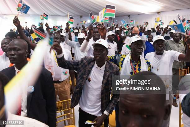 Attendees wave South Sudan flags as Pope Francis arrives for a meeting with internally displaced persons at the Freedom Hall in Juba, South Sudan, on...