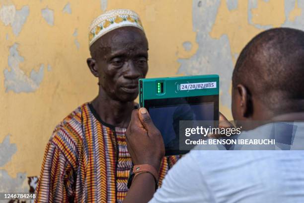 Independent National Electoral Commission officials use the Bi-Modal Voter Accreditation System to accredit voters during a mock accreditation...