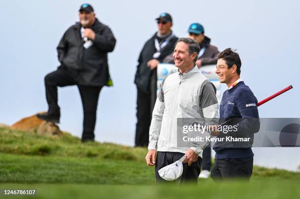 Brian Niccol, chief executive officer of Chipotle Mexican Group, smiles with Viktor Hovland of Norway on the ninth hole green following the second...