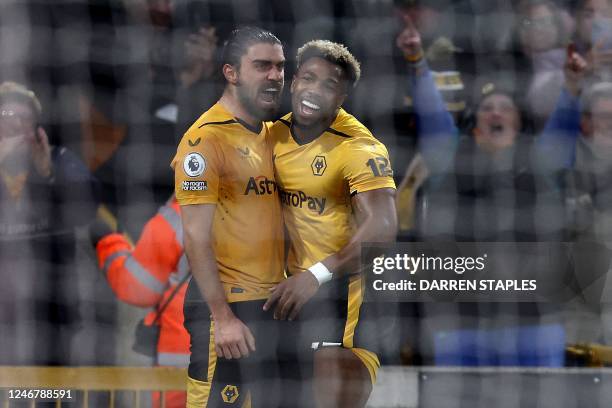 Wolverhampton Wanderers' Portuguese midfielder Ruben Neves celebrates with Wolverhampton Wanderers' Spanish midfielder Adama Traore after scoring his...