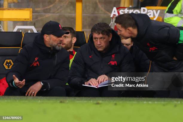 Jurgen Klopp manager of Liverpool speaks with assistants Peter Krawietz and Pepijn Lijnders during the Premier League match between Wolverhampton...