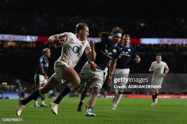 England's wing Max Malins runs with the ball to score his second try during the Six Nations international rugby union match between England and...