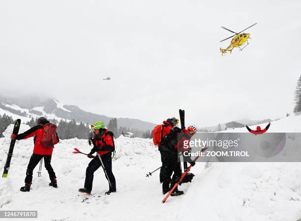 Photo taken on February 4, 2023 shows rescuers during their mission near Fieberbrunn, western Austria. - Avalanches in Austria and Switzerland have...