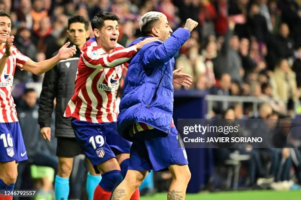 Atletico Madrid's Argentinian forward Angel Correa celebrates with Atletico Madrid's Spanish forward Alvaro Morata on the sidelines after scoring his...