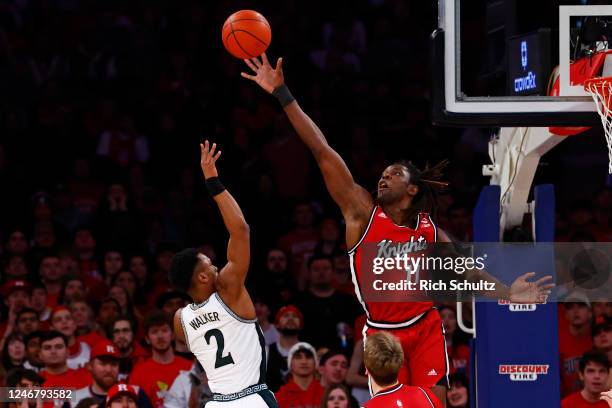 Clifford Omoruyi of the Rutgers Scarlet Knights attempts to block a shot by Tyson Walker of the Michigan State Spartans during the first half of a...