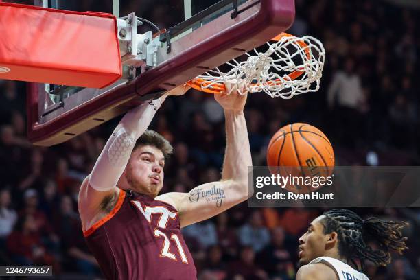 Grant Basile of the Virginia Tech Hokies dunks the ball over Armaan Franklin of the Virginia Cavaliers in the second half during a game at Cassell...
