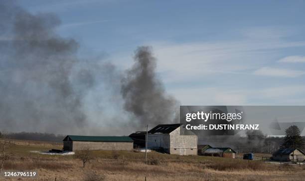 Smoke rises from a derailed cargo train in East Palestine, Ohio, on February 4, 2023. - The train accident sparked a massive fire and evacuation...
