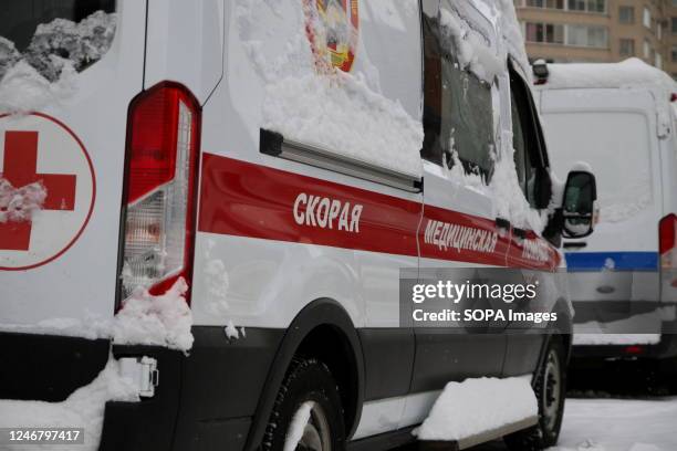 The inscription ambulance on the ambulance car, which is parked on the street in Saint Petersburg.