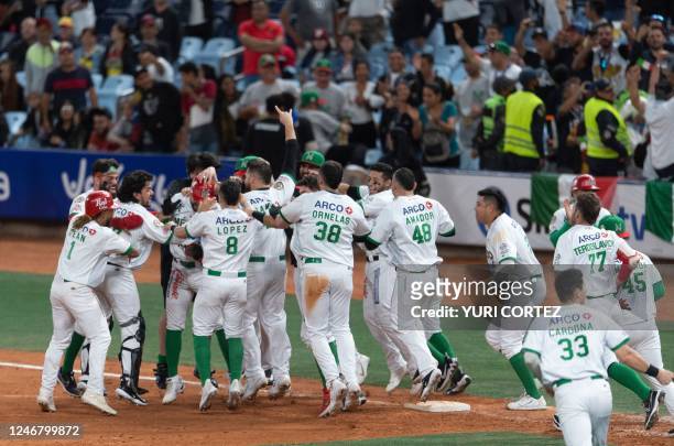 Players of Mexico's Caneros de los Mochis celebrate after defeating Colombia's Vaqueros de Monteria during their Caribbean Series game at the...