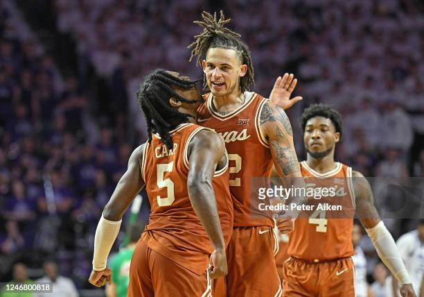 Christian Bishop and Marcus Carr of the Texas Longhorns celebrate after beating the Kansas State Wildcats 69-66 at Bramlage Coliseum on February 4,...