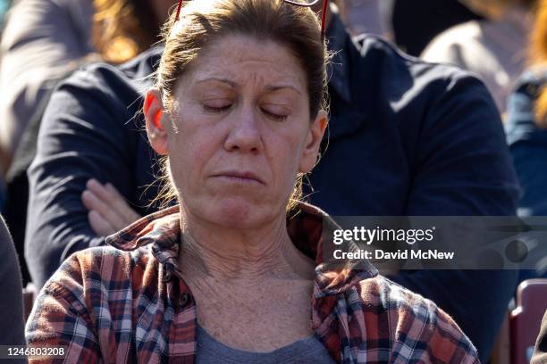 Women appears contemplative during a reading by host Beth Pratt, regional executive director of the National Wildlife Federation, at a "Celebration...