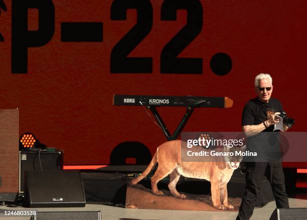 National Geographic photographer Steve Winter walks past a cutout of P-22, made from his famous image of the cougar with the Hollywood sign, after...