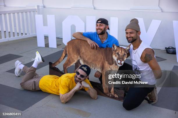 People pose with a photo of P-22 during a "Celebration of Life" public memorial for "P-22," the celebrated mountain lion, on February 4, 2023 in Los...