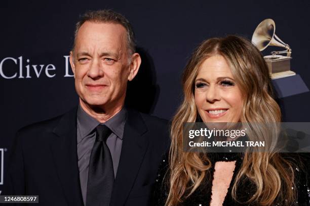 Actor Tom Hanks and his wife US singer and actress Rita Wilson arrive for the Recording Academy and Clive Davis pre-Grammy gala at the Beverly Hilton...