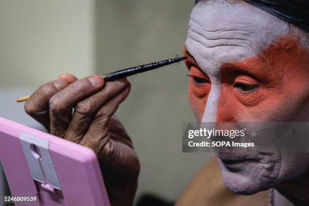 Chinese opera performer seen putting on makeup before performing at Bangkok's Chinatown. Due to the Bangkok design week 2023, Chinese opera take...