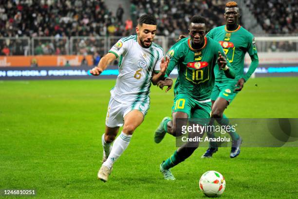 Ahmed Kendouci of Algeria in action against Pape Amadou Diallo of Senegal during the 7th African Nations Championship Final match between Algeria and...