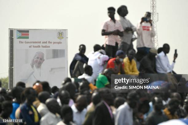 Billboard with a picture of Pope Francis on is seen as attendees gather as he presides over the holy mass at the John Garang Mausoleum in Juba, South...