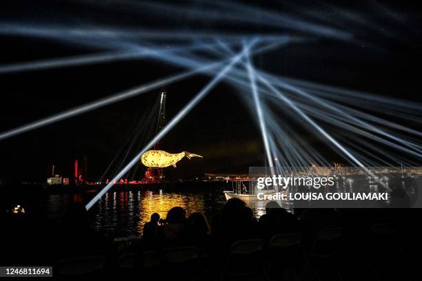 People attend a light show during a ceremony marking the two-days inauguration of the 2023 European Capital of Culture in the industrial town of...