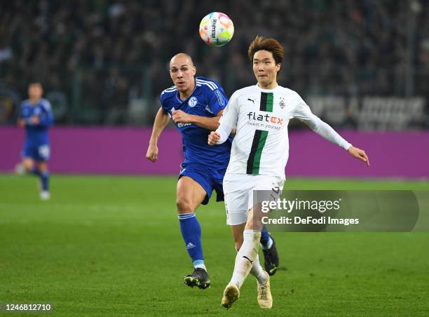 Michael Frey of FC Schalke 04 and Ko Itakura of Borussia Moenchengladbach battle for the ball during the Bundesliga match between Borussia...