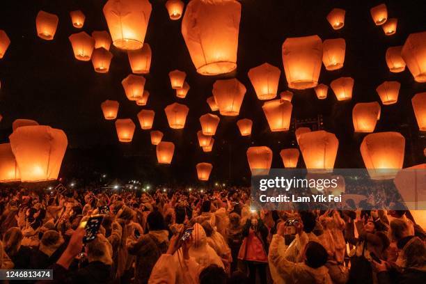 Tourists release sky lanterns during the Pingxi Lantern Festival on February 5, 2023 in Taipei, Taiwan. The Pingxi Lantern Festival has been held for...