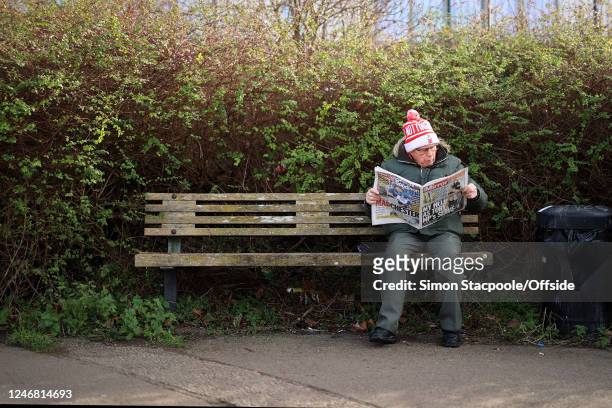 Man sits on a park bench reading the Daily Mirror newspaper before the Premier League match between Nottingham Forest and Leeds United at City Ground...