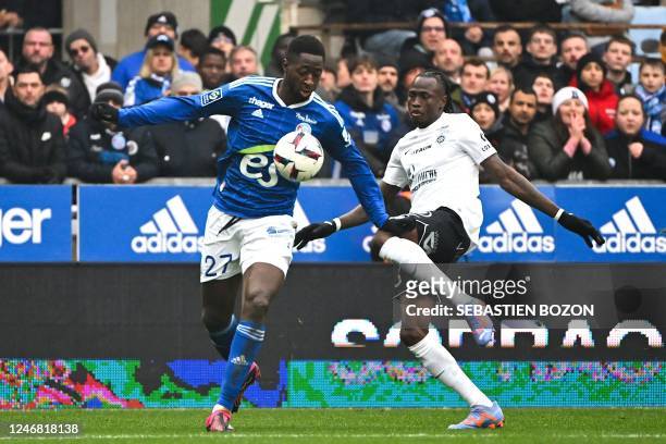 Strasbourgs French midfielder Ibrahima Sissoko fights for the ball with Montpelliers Guinean defender Issiaga Sylla during the French L1 football...