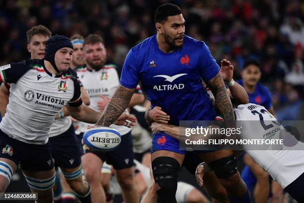 Italy's full back Edoardo Padovani tackles France's lock Romain Taofifenua during the Six Nations international rugby union match between Italy and...