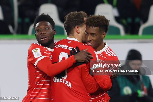 Bayern Munich's French forward Kingsley Coman celebrates after scoring the 0-2 goal with team mates Bayern Munich's German midfielder Leon Goretzka...