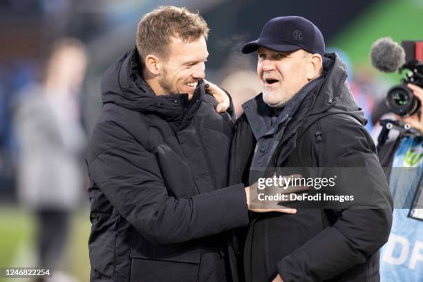 Coach Julian Nagelsmann of FC Bayern München and Joerg Schmadtke of VfL Wolfsburg gesture prior to the Bundesliga match between VfL Wolfsburg and FC...