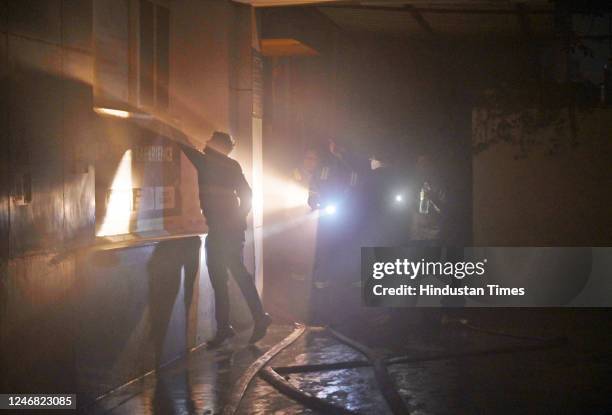 Firefighters try to douse a fire that broke out on Sunday evening at a VMC Coaching Center in Sector 4, on February 5, 2023 in Noida, India. Fire...