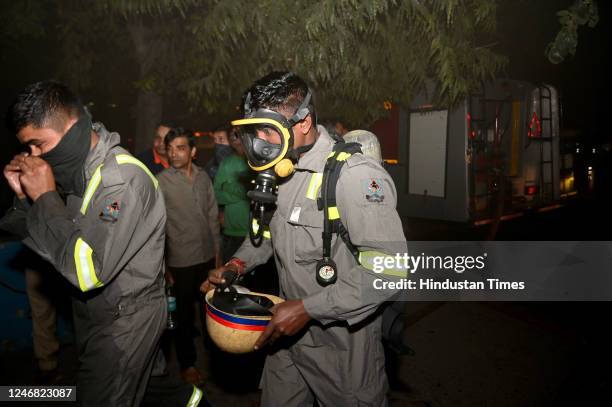 Firefighters try to douse a fire that broke out on Sunday evening at a VMC Coaching Center in Sector 4, on February 5, 2023 in Noida, India. Fire...