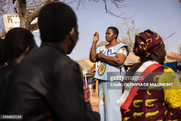 Woman translates the mass in sign language during a pilgrimage to Yagma, on the outskirts of Ouagadougou, on February 5, 2023. - Thousands of...