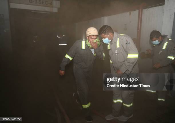 Firefighters try to douse a fire that broke out on Sunday evening at a VMC Coaching Center in Sector 4, on February 5, 2023 in Noida, India. Fire...