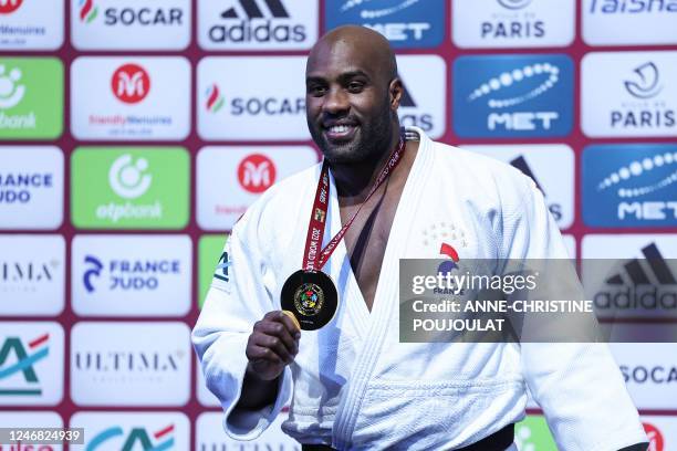 Gold medallist France's Teddy Riner poses during the podium ceremony after winning against Japan's Hyoga Ota in the final of the men's +100kg...