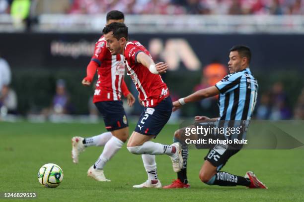 Alan Mozo of Chivas fights for the ball with Pablo Barrera of Queretaro during the 5th round match between Chivas and Queretaro as part of the Torneo...