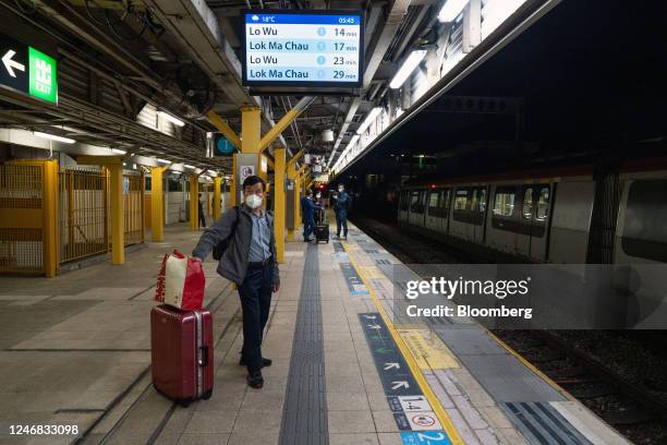 Travelers heading to mainland China wait for a subway train at MTR Corp. Sheung Shui station in Hong Kong, China, on Monday, Feb. 6, 2023. The border...