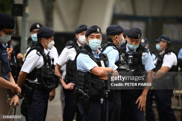 Police keep watch outside a court in Hong Kong on February 6, 2023 as the trial of 47 of Hong Kongs most prominent pro-democracy figures begins in...