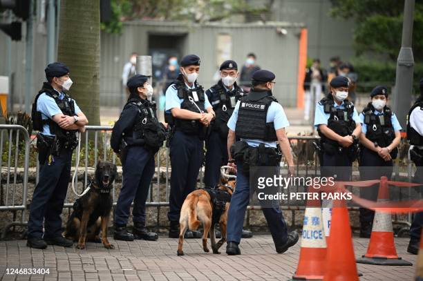 Police keep watch outside a court in Hong Kong on February 6, 2023 as the trial of 47 of Hong Kongs most prominent pro-democracy figures begins in...