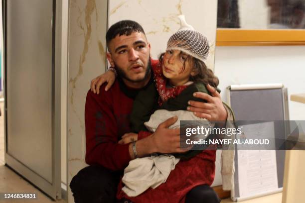 Young injured girl awaits treatment at a hospital follwoing an earthquake, in the Syrian border town of Azaz in the rebel-held north of the Aleppo...