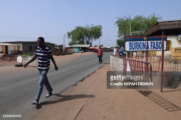 Man walks through the border from Burkina Faso to Ghana in Paga, northern Ghana, on December 6, 2022. - Ghana along with Gulf of Guinea neighbours...