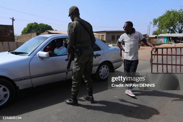 Security officer interacts with a driver at the Burkina Faso border to the Ghana in Paga, northern Ghana, on December 6, 2022. - Ghana along with...