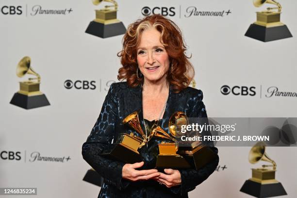 Musician Bonnie Raitt holds the awards for Best Americana Performance, Best American Roots Song, and Song of the Year for Just Like That in the press...