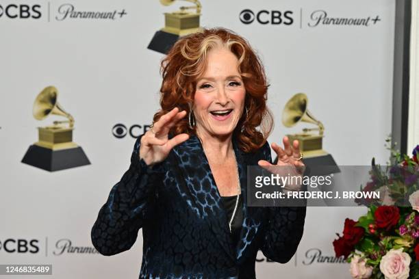 Musician Bonnie Raitt holds the awards for Best Americana Performance, Best American Roots Song, and Song of the Year for Just Like That in the press...